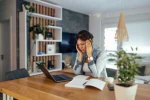 Woman feeling overwhelmed due to working too much.